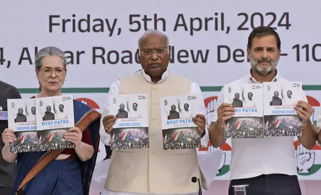 FILE- India’s opposition Congress party leaders from left, Sonia Gandhi, Mallikarjun Kharge, and Rahul Gandhi, display copies of party’s election manifesto during a press conference in New Delhi, India, April 5, 2024. India's 6-week-long general election starts on April 19 and results will be announced on June 4. (AP Photo/Manish Swarup, File)