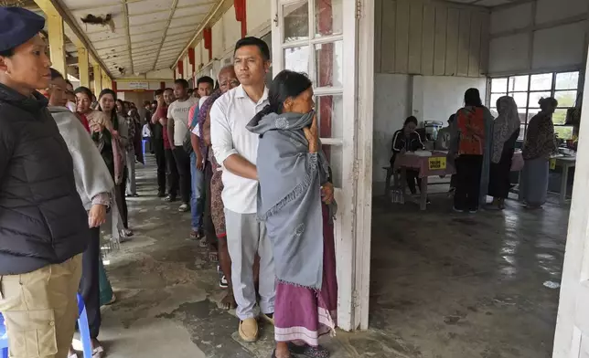 Angami Nagas stand in queues to cast their votes in Chedema village, in the northeastern Indian state of Nagaland, Friday, April 19, 2024. (AP Photo/Yirmiyan Arthur)