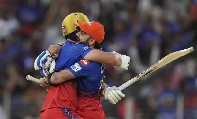 Royal Challengers Bengaluru's Will Jacks and teammate Virat Kohli, right, celebrate their team's victory in the Indian Premier League cricket match between Gujarat Titans and Royal Challengers Bengaluru in Ahmedabad, India, Sunday, April 28, 2024. (AP Photo /Ajit Solanki)