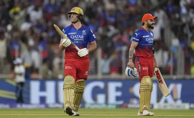 Royal Challengers Bengaluru's Will Jacks and teammate Virat Kohli, right, smile after their team won in the Indian Premier League cricket match between Gujarat Titans and Royal Challengers Bengaluru in Ahmedabad, India, Sunday, April 28, 2024. (AP Photo /Ajit Solanki)