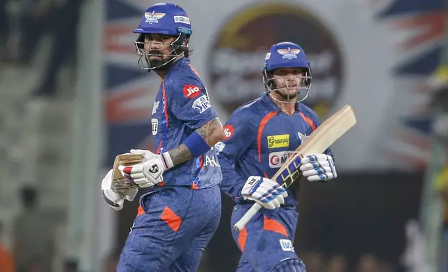 Lucknow Super Giants' captain KL Rahul, , left, and his batting partner Quinton de Kock run between the wickets during the Indian Premier League cricket match between Chennai Super Kings and Lucknow Super Giants in Lucknow, India, Friday, April 19, 2024. (AP Photo/Surjeet Yadav)