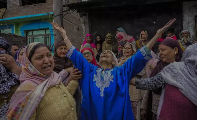 Family members and relatives cry after a boat carrying people including children capsized in Jhelum river on the outskirts of Srinagar, Indian controlled Kashmir, Tuesday, April. 16, 2024. Rescue operation is continuing for the several missing people. (AP Photo/Mukhtar Khan)