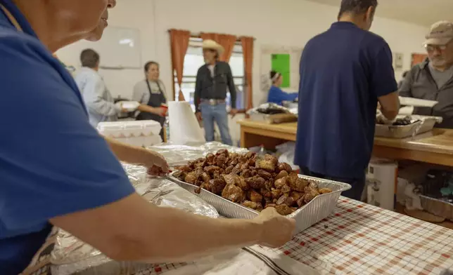 A tray of fried pork is served at the Springfield United Methodist Church's annual wild onion dinner in Okemah, Okla., on April 6, 2024. The church is on the Muscogee Nation's reservation, where the meals using wild onions picked by the community are an annual tradition. (AP Photo/Brittany Bendabout)