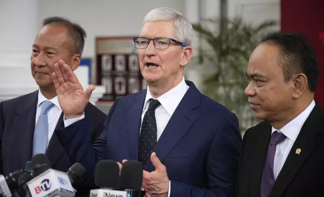 Apple CEO Tim Cook ,center, talks to journalist during a joint press conference with Indonesian Minister of Industry Agus Gumiwang Kartasasmita, left, and Indonesian Minister of Communication and Information Technology Budi Arie Setiadi, right, after a meeting with Indonesian President Joko Widodo at the palace in Jakarta, Indonesia, Wednesday, April 17, 2024.(AP Photo/Achmad Ibrahim)