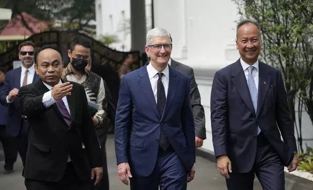 Apple CEO Tim Cook, center, walks with Indonesia’s Minister of industry Agus Gumiwang Kartasasmita, right, and Minister of Communication and Information Technology Budi Arie Setiadi, left, after a meeting with President Joko Widodo at the palace in Jakarta, Indonesia, Wednesday, April 17, 2024.(AP Photo/Achmad Ibrahim)