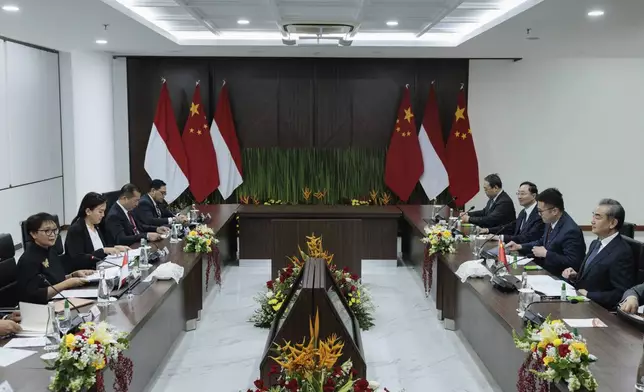 Indonesian Foreign Minister Retno Marsudi, left, speaks during their bilateral meeting with Chinese Foreign Minister Wang Yi, right, in Jakarta, Indonesia, Thursday, April 18, 2024. (Yasuyoshi Chiba/Pool Photo via AP)