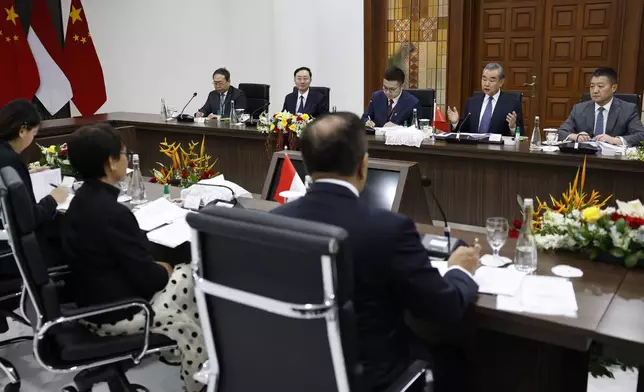 Chinese Foreign Minister Wang Yi, second right, speaks during a bilateral meeting with Indonesian Foreign Minister Retno Marsudi, bottom second left, in Jakarta, Indonesia, Thursday, April 18, 2024. (Willy Kurniawan/Pool Photo via AP)
