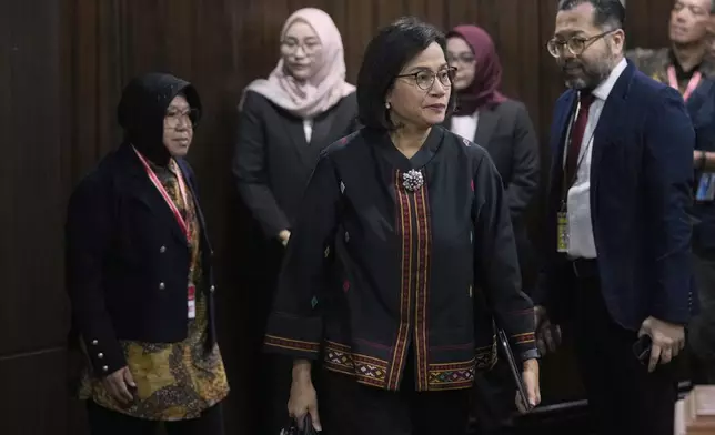 Indonesian Finance Minister Sri Mulyani Indrawati, center, and Social Affairs Minister Tri Rismaharini, left, arrive to attend a hearing on the presidential election result dispute at the Constitutional Court in Jakarta, Indonesia, Friday, April 5, 2024. (AP Photo/Dita Alangkara)