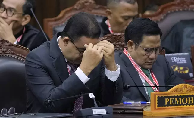 Presidential candidate Anies Baswedan, left, and his running mate Muhaimin Iskandar react during their election appeal hearing at the Constitutional Court in Jakarta, Indonesia, Monday, April 22, 2024. The country's top court on Monday rejected appeals lodged by two losing presidential candidates who are demanding a revote, alleging widespread irregularities and fraud at the February polls. (AP Photo/Dita Alangkara)