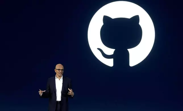 Microsoft CEO Satya Nadella speaks as the logo of Github, a subsidiary of Microsoft Corp, is displayed on the screen during an event titled "Microsoft Build: AI Day" in Jakarta, Indonesia, Tuesday, April 30, 2024. Microsoft will invest $1.7 billion over the next four years in new cloud and artificial intelligence infrastructure in Indonesia — the single largest investment in Microsoft's 29-year history in the country — Nadella said Tuesday. (AP Photo/Dita Alangkara)