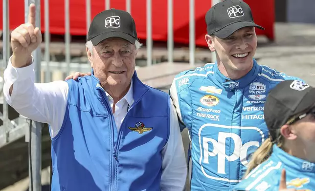 FILE - Team Penske driver Josef Newgarden, right, celebrates his victory with team owner Roger Penske after the IndyCar Grand Prix of St. Petersburg auto race, Sunday, March 10, 2024, in St. Petersburg, Fla. Team Penske suffered a humiliating disqualification Wednesday, April 24, when reigning Indianapolis 500 winner Josef Newgarden was stripped of his victory in the season-opening race for manipulating his push-to-pass system. Penske teammate Scott McLaughlin, who finished third in the opener on the downtown streets of St. Petersburg, Florida, was also disqualified. (AP Photo/Mike Carlson, File)