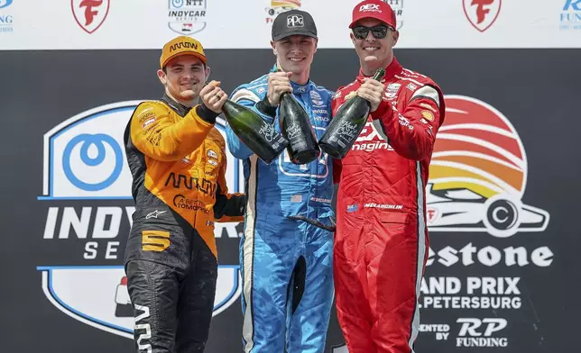 FILE - Team Penske driver Josef Newgarden, center, celebrates his first place finish along with second place finisher Arrow McLaren driver Pato O'Ward of Mexico, left, and third place finisher Team Penske driver Scott McLaughlin of New Zealand in the IndyCar Grand Prix of St. Petersburg auto race, Sunday, March 10, 2024, in St. Petersburg, Fla. Team Penske suffered a humiliating disqualification Wednesday, April 24, when reigning Indianapolis 500 winner Josef Newgarden was stripped of his victory in the season-opening race for manipulating his push-to-pass system. Penske teammate Scott McLaughlin, who finished third in the opener on the downtown streets of St. Petersburg, Florida, was also disqualified. (AP Photo/Mike Carlson)
