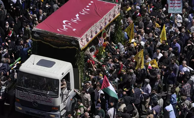 Iranian mourners gather around a truck carrying the coffins of Revolutionary Guard members killed in an airstrike widely attributed to Israel that destroyed Iran's Consulate in Syria on Monday, in a funeral procession in Tehran, Iran, Friday, April 5, 2024. The public funeral coincided with Iran's annual rally Quds Day, or Jerusalem Day, a traditional show of support for the Palestinians that has been held on the last Friday of the holy month of Ramadan since the 1979 Islamic Revolution. (AP Photo/Vahid Salemi)