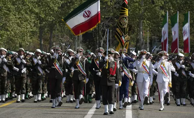Iranian army members march during Army Day parade at a military base in northern Tehran, Iran, Wednesday, April 17, 2024. In the parade, Iranian President Ebrahim Raisi warned that the "tiniest invasion" by Israel would bring a "massive and harsh" response, as the region braces for potential Israeli retaliation after Iran's attack over the weekend. (AP Photo/Vahid Salemi)