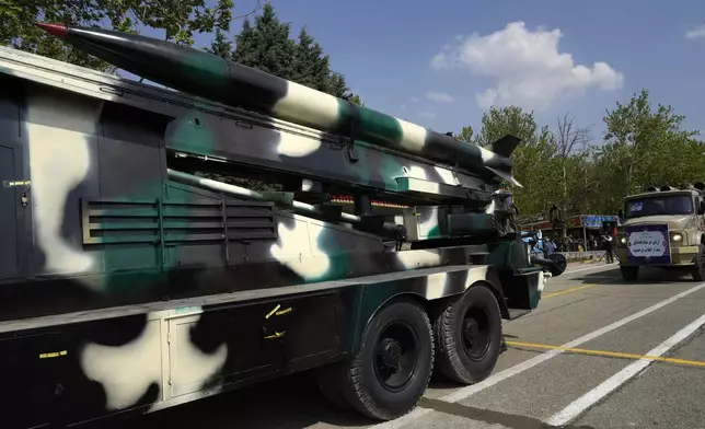 A missile is carried on a truck during Army Day parade at a military base in northern Tehran, Iran, Wednesday, April 17, 2024. In the parade, President Ebrahim Raisi warned that the "tiniest invasion" by Israel would bring a "massive and harsh" response, as the region braces for potential Israeli retaliation after Iran's attack over the weekend. (AP Photo/Vahid Salemi)