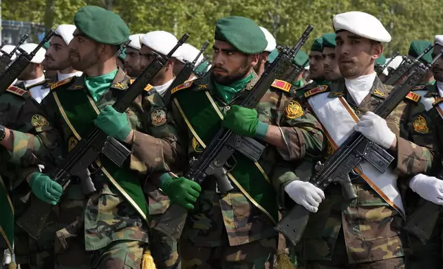 Iranian army members march during Army Day parade at a military base in northern Tehran, Iran, Wednesday, April 17, 2024. In the parade Iran's President Ebrahim Raisi warned that the "tiniest invasion" by Israel would bring a "massive and harsh" response, as the region braces for potential Israeli retaliation after Iran's attack over the weekend. (AP Photo/Vahid Salemi)