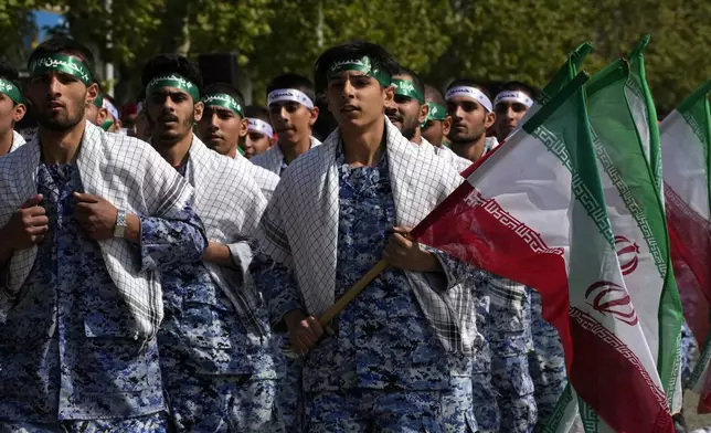 Volunteer troops of the Iranian army march during Army Day parade at a military base in northern Tehran, Iran, Wednesday, April 17, 2024. In the parade, President Ebrahim Raisi warned that the "tiniest invasion" by Israel would bring a "massive and harsh" response, as the region braces for potential Israeli retaliation after Iran's attack over the weekend. (AP Photo/Vahid Salemi)