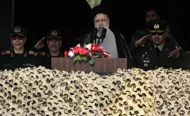 Iranian President Ebrahim Raisi speaks during Army Day parade at a military base in northern Tehran, Iran, Wednesday, April 17, 2024. Raisi warned that the "tiniest invasion" by Israel would bring a "massive and harsh" response, as the region braces for potential Israeli retaliation after Iran's attack over the weekend. (AP Photo/Vahid Salemi)