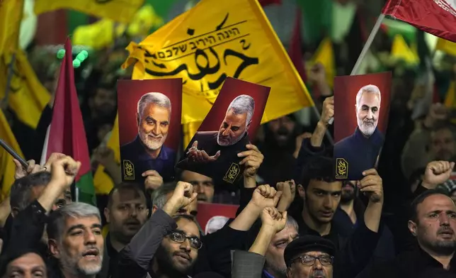 Iranian protesters chant slogans as they hold up posters of the late Iranian Revolutionary Guard Gen. Qassem Soleimani, who was killed in a U.S. drone attack in 2020, during their anti-Israeli gathering to condemn killing members of the Iranian Revolutionary Guard in Syria, at the Felestin (Palestine) Sq. in downtown Tehran, Iran, Monday, April 1, 2024. An Israeli airstrike that demolished Iran's consulate in Syria killed two Iranian generals and five officers, Syrian and Iranian officials said Monday. (AP Photo/Vahid Salemi)