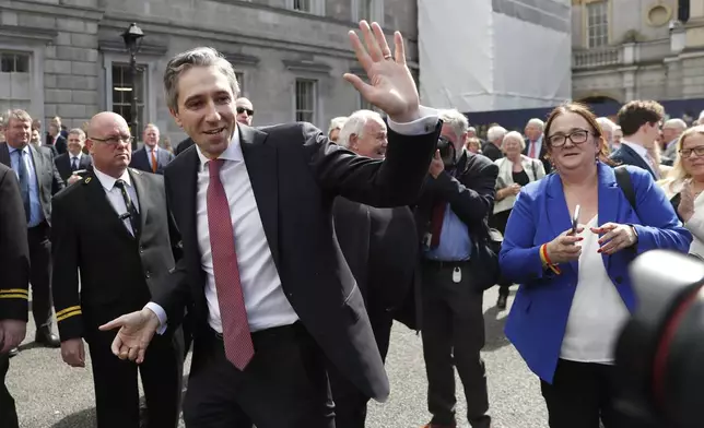 The new Prime Minister of Ireland Simon Harris waves at the media and the crowd following his election outside Leinster House in Dublin, Ireland, Tuesday, April 9, 2024. Harris was selected after the previous Prime Minister Leo Varadkar resigned. (AP Photo/Peter Morrison)