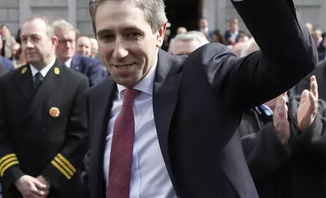 The new Prime Minister of Ireland Simon Harris waves at the media and the crowd following his election outside Leinster House in Dublin, Ireland, Tuesday, April 9, 2024. Harris was selected after the previous Prime Minister Leo Varadkar resigned. (AP Photo/Peter Morrison)
