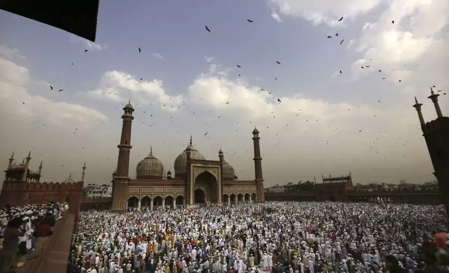 FILE - Muslims hug and greet each other after offering Eid al-Fitr prayers at the Jama Masjid in New Delhi, India, on Wednesday, June 5, 2019. (AP Photo/Manish Swarup, File)