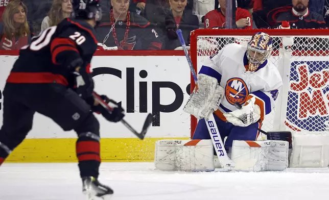 New York Islanders goaltender Semyon Varlamov (40) catches the shot of Carolina Hurricanes' Sebastian Aho (20) during the first period in Game 2 of an NHL hockey Stanley Cup first-round playoff series in Raleigh, N.C., Monday, April 22, 2024. (AP Photo/Karl B DeBlaker)