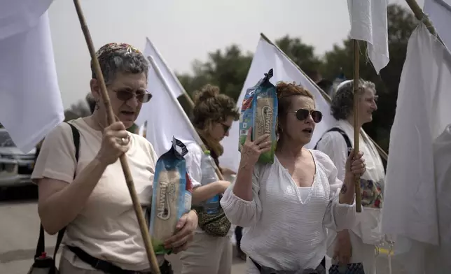 A delegation of American and Israeli rabbis from Rabbis for Ceasefire and other activists march towards the Erez crossing to the Gaza Strip with food aid for Gaza civilians and to call for a ceasefire, in southern Israel, Friday, April 26, 2024. (AP Photo/Maya Alleruzzo)