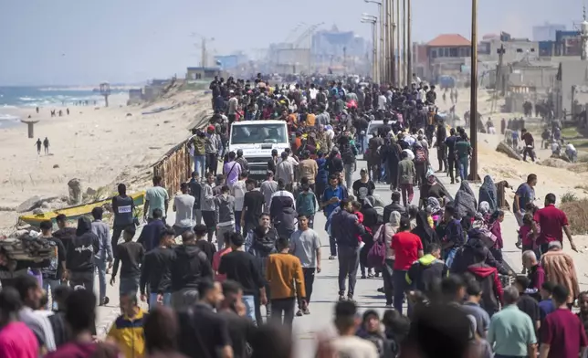 Displaced Palestinians trying to walk back from central Gaza Strip to northern Gaza Strip , Sunday, April 14, 2024. (AP Photo/Abdel Kareem Hana)
