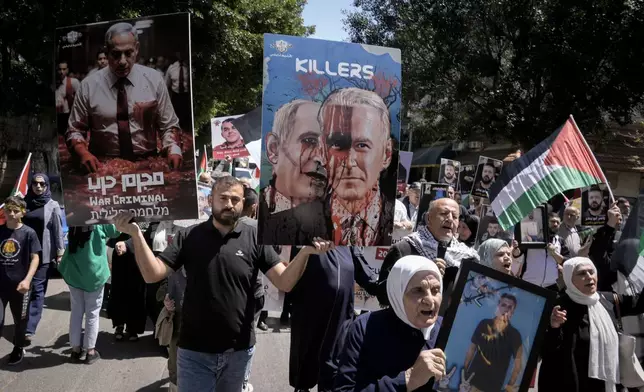 Palestinians hold photographs of prisoners jailed in Israel and posters depicting Israeli Prime Minister Benjamin Netanyahu and U.S. President Joe Biden, during a rally marking the annual prisoners' day in the West Bank city of Nablus, Wednesday, April 17, 2024. (AP Photo/Majdi Mohammed)