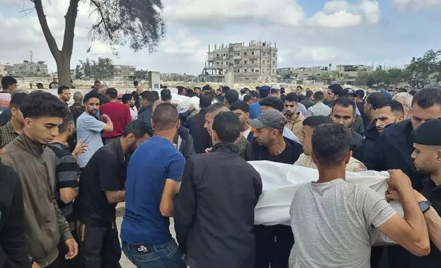Mourners carry the bodies of members of the Abu Taha family who were killed in an Israeli airstrike, during their funeral at Al-Salam cemetery, east of Rafah, Gaza Strip. Monday, April 29, 2024. (AP Photo/Mohammad Jahjouh)