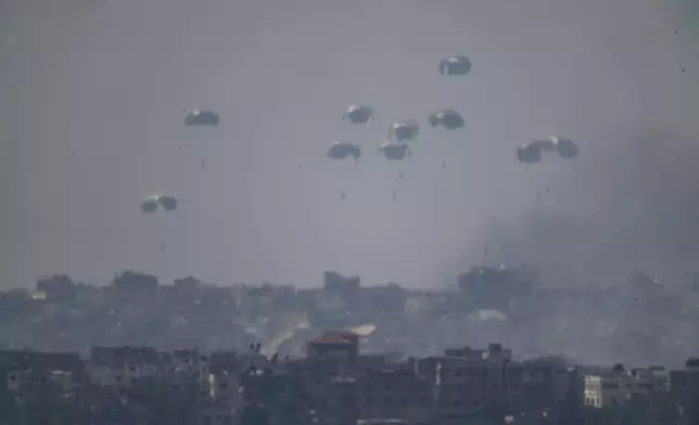 Parachutes drop supplies into the northern Gaza Strip as seen from southern Israel, Tuesday, April 9, 2024. (AP Photo/Leo Correa)