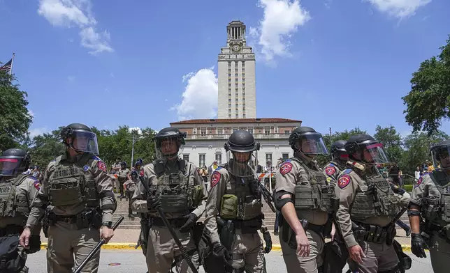 Texas state troopers line up below the University of Texas at Austin Tower to clear a pro-Palestinian encampment on the campus Monday, April 29, 2024, in Austin, Texas. (Aaron E. Martinez/Austin American-Statesman via AP)