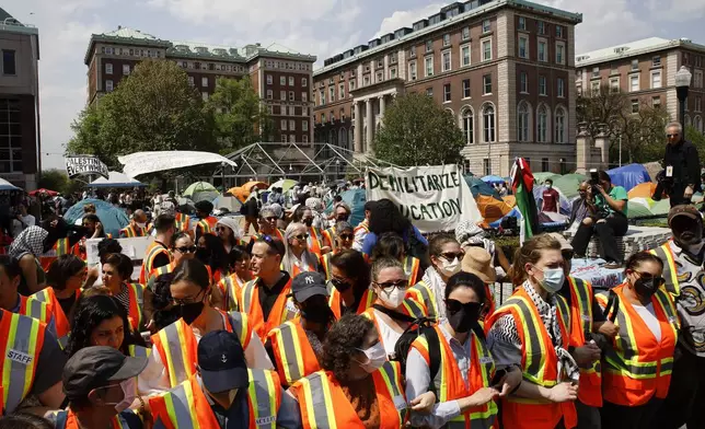 Columbia University faculty and staff gather on the campus in solidarity with student protesters who are demonstrating against the university's investments in Israel, Monday, April 29, 2024, in New York. (AP Photo/Stefan Jeremiah)