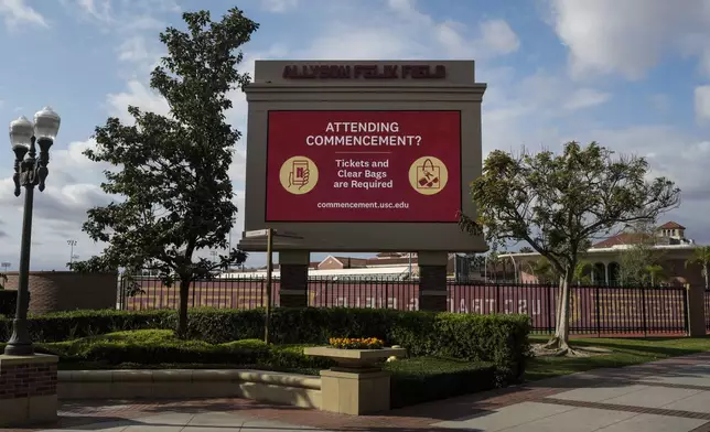 A display shows commencement-related information on the University of Southern California campus in Los Angeles, Thursday, April 25, 2024. The university canceled its main graduation ceremony Thursday and dozens more college students were arrested at other campuses nationwide as protests against the Israel-Hamas war continued to spread. (AP Photo/Jae C. Hong)