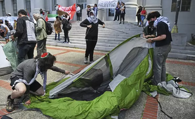 Pro-Palestinian protesters begin to set up tents in front of Sproul Hall during a planned protest on the campus of UC Berkeley in Berkeley, Calif., on Monday, April 22, 2024. Hundreds of pro-Palestinian protesters staged a demonstration in front of Sproul Hall where they set up a tent encampment and are demanding a permanent cease-fire in the war between Israel and Gaza. (Jose Carlos Fajardo/Bay Area News Group via AP)