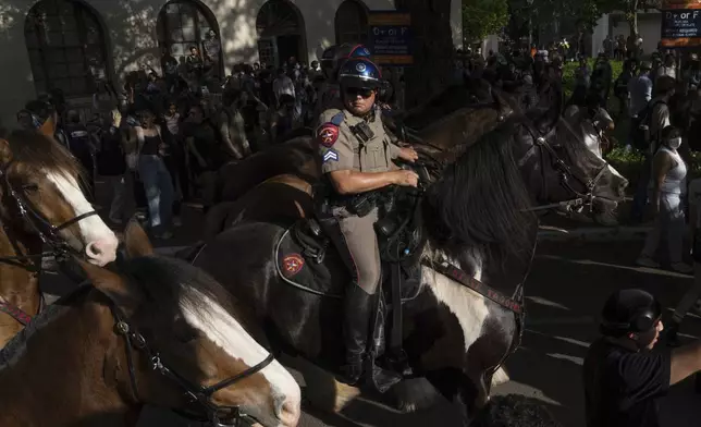 State troopers on horses push back protesters during a pro-Palestinian protest at the University of Texas, Wednesday April 24, 2024, in Austin, Texas. (Mikala Compton/Austin American-Statesman via AP)