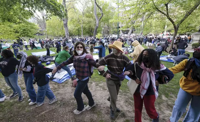 People lock arms during a Pro-Palestinian protest on Penn's campus in Philadelphia on Thursday, April 25, 2024. (Elizabeth Robertson/The Philadelphia Inquirer via AP)