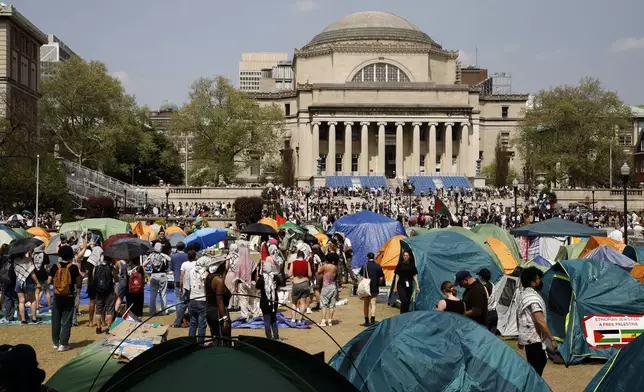 Student protesters gather in protest inside their encampment on the Columbia University campus, Monday, April 29, 2024, in New York. Protesters of the war in Gaza who are encamped at Columbia University have defied a deadline to disband with chants, clapping and drumming. (AP Photo/Stefan Jeremiah)