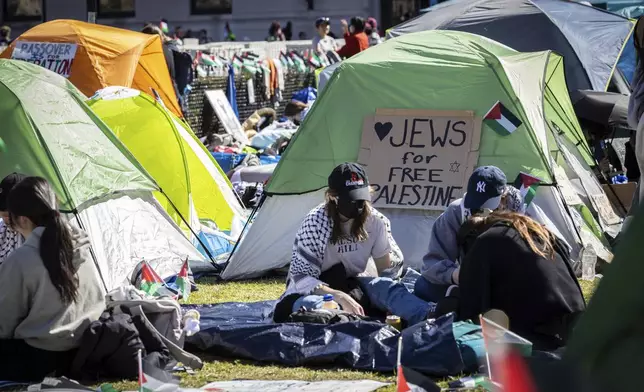 Student protesters sit in front of a tent during the Pro-Palestinian protest at the Columbia University campus in New York, Monday April 22, 2024. (AP Photo/Stefan Jeremiah)