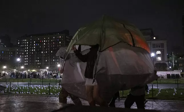 Students protesters with the Gaza solidarity encampment move tents from the South West lawn at Columbia University on Tuesday, April 30, 2024 in New York. Columbia Students for Justice in Palestine called for mobilization close to midnight before taking over Hamilton Hall. (Marco Postigo Storel via AP)