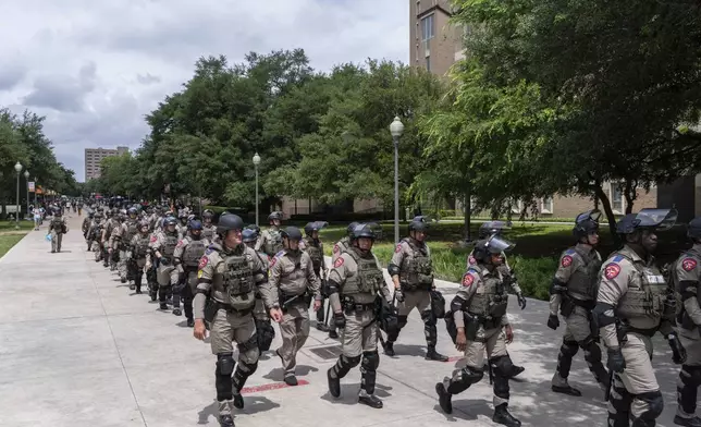 Texas state troopers march down Speedway during a pro-Palestinian protest at the University of Texas, Wednesday, April 24, 2024, in Austin, Texas. (Mikala Compton/Austin American-Statesman via AP)