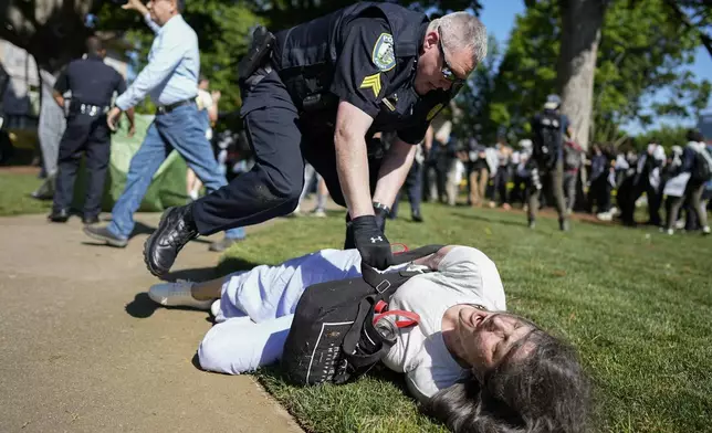 A police officer detains a protester on the campus of Emory Univeristy during an pro-Palestinian demonstration, Thursday, April 25, 2024, in Atlanta. (AP Photo/Mike Stewart)