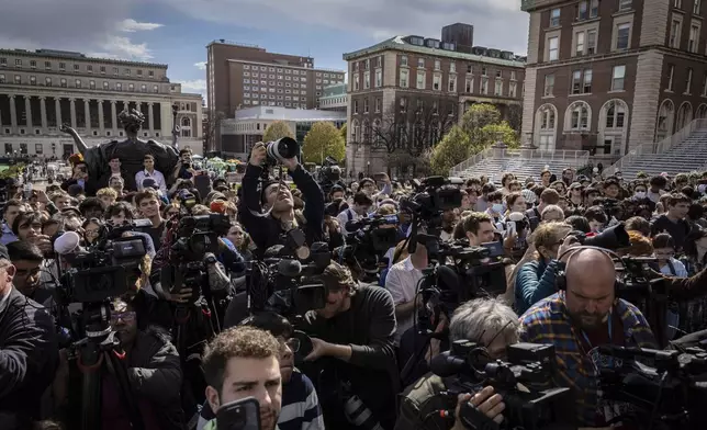 Students and press look on as Speaker of the House Mike Johnson, R-La., speaks to the media on the Lower Library steps on Columbia University's campus in New York, on Wednesday, April 24, 2024. (AP Photo/Stefan Jeremiah)