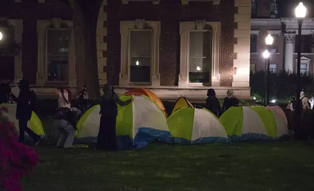 Students protesters with the Gaza solidarity encampment move tents from the South West lawn at Columbia University on Tuesday, April 30, 2024 in New York. Columbia Students for Justice in Palestine called for mobilization close to midnight before taking over Hamilton Hall. (Marco Postigo Storel via AP)