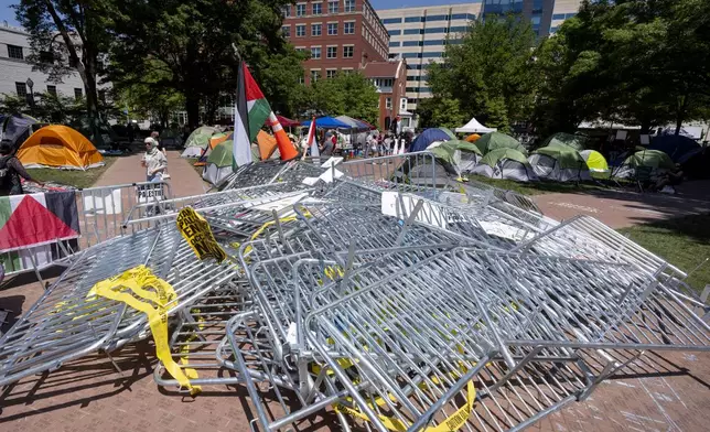 Barricades torn down by demonstrators are piled in the center of an encampment by students protesting against the Israel-Hamas war at George Washington University on Monday, April 29, 2024, in Washington. (AP Photo/Mark Schiefelbein)