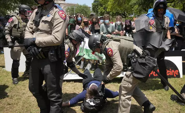 State troopers arrest a person at a pro-Palestinian protest at the University of Texas in Austin, Texas, Monday, April 29, 2024. (Jay Janner/Austin American-Statesman via AP)