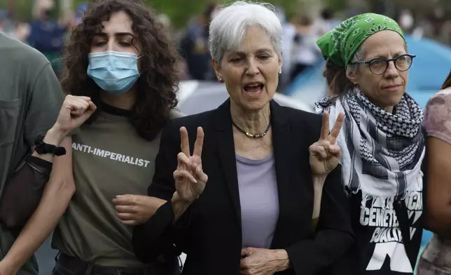 Green Party presidential candidate Jill Stein, center, links arms with others while surrounding pro-Palestinian protesters as police show up to their encampment on the campus of Washington University, Saturday, April 27, 2024, in St. Louis, Mo. Dozens were arrested during the protest. (Christine Tannous/St. Louis Post-Dispatch via AP)