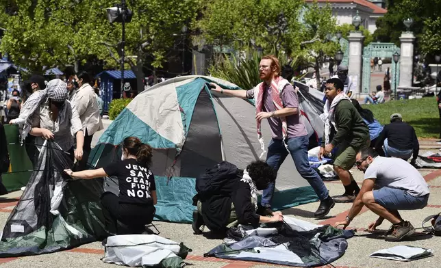Pro-Palestinians protesters begin to set up tents in front of Sproul Hall during a planned protest on the campus of UC Berkeley in Berkeley, Calif., Monday, April 22, 2024. Hundreds of pro-Palestinian protesters staged a demonstration in front of Sproul Hall where they set up a tent encampment and are demanding a permanent cease-fire in the war between Israel and Gaza. (Jose Carlos Fajardo/Bay Area News Group via AP)