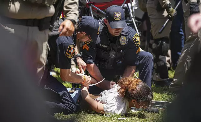 University of Texas at Austin police arrest a protester at a pro-Palestinian encampment on the campus Monday, April 29, 2024, in Austin, Texas. (Aaron E. Martinez/Austin American-Statesman via AP)